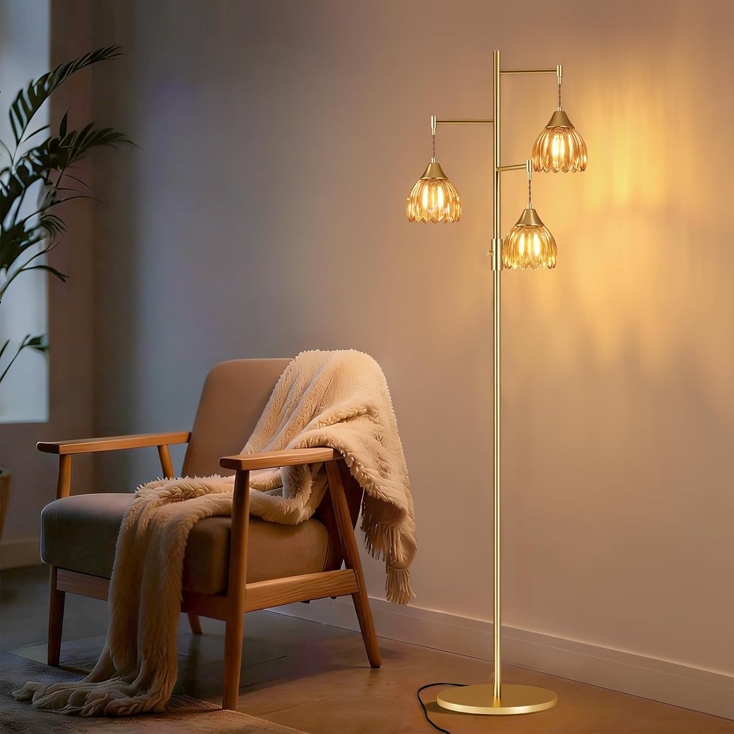 Gold floor lamp with three amber glass shades beside a reading chair