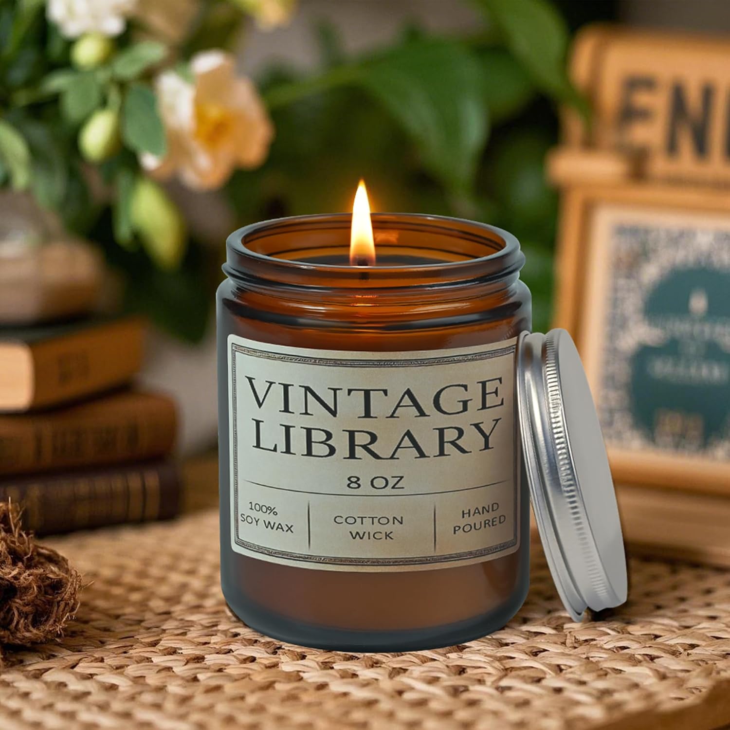 Vintage Library soy candle in an amber jar beside a stack of books